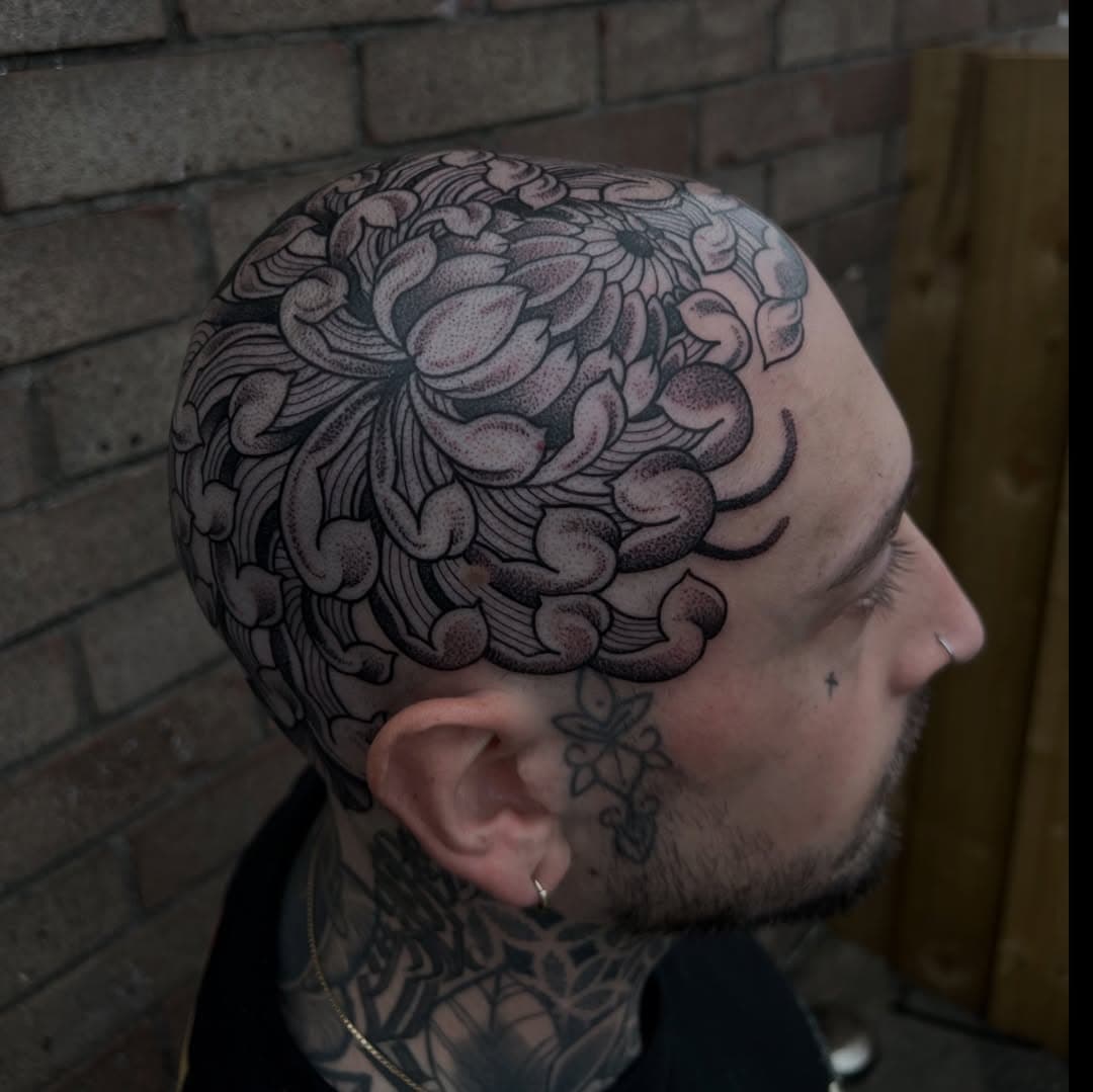 Had the pleasure of creating this chrysanthemum across the head! I’ve alwayssss wanted to work on a project like this, to create as much flow as possible while framing the face. Thank you so much for the trust Milan! Such a trooper getting this done 💪🏼🫡 #tattoo #bristol #bristoltattooers #blackwork #dotwork #chrysanthemum #flower #flowerstagram #floraltattoo #chrysanthemumtattoo #headtattoo #headbanger