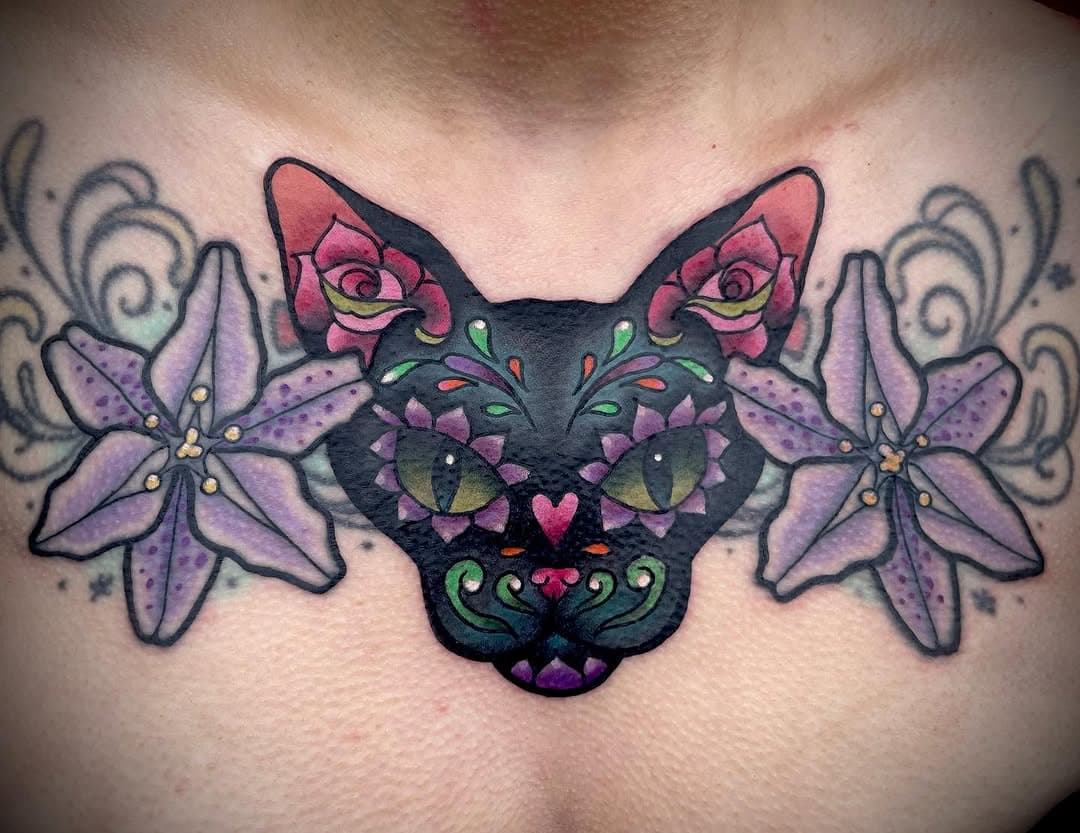 Loving this work in progress spruce up of Tina’s chest piece. The lillies were already there so I re outlined them to give the black lines more contrast against the new cat face. #dayofthedead #dayofthedeadtattoo #cat #cattattoo #flowertattoos #chesttattoo