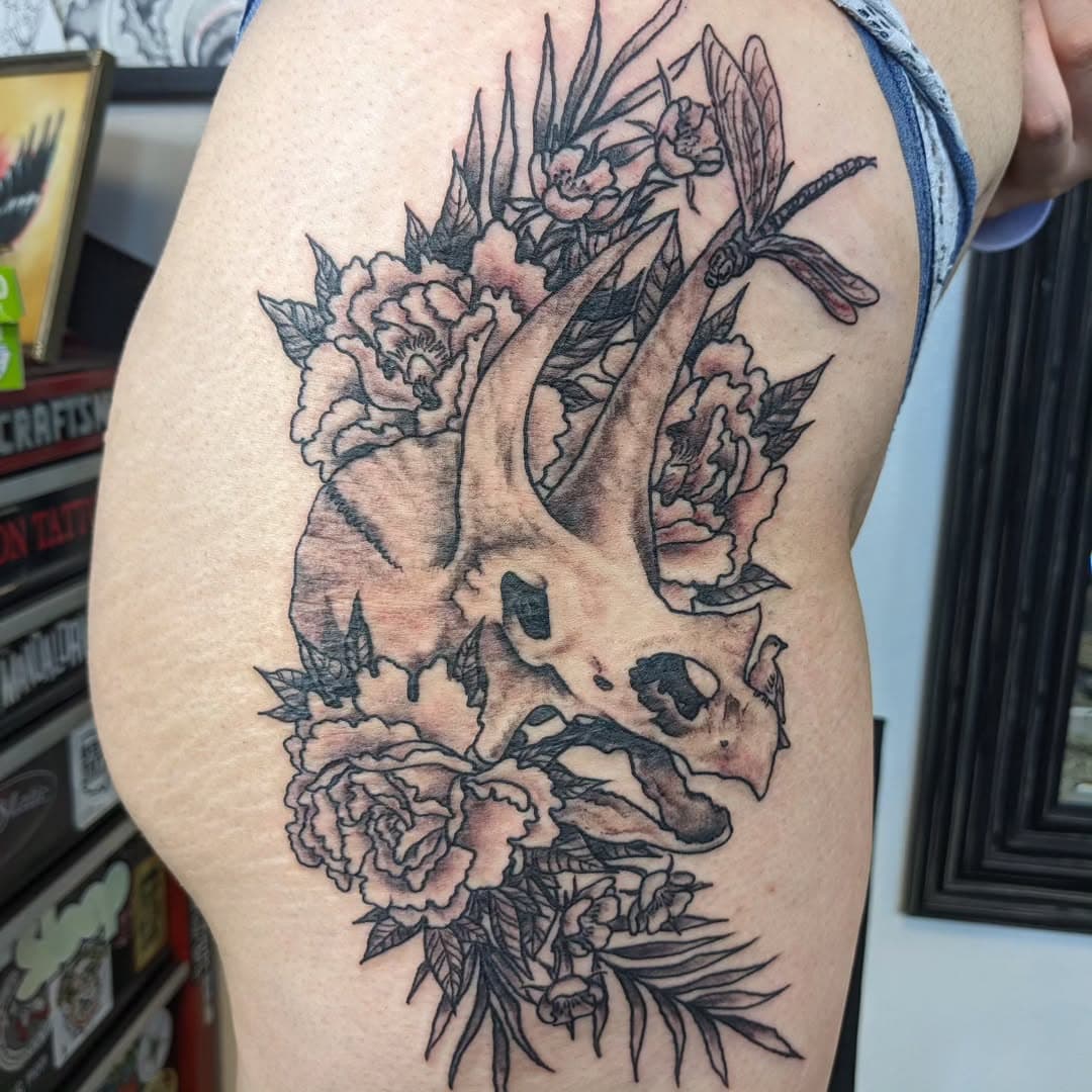 Triceratops skull with peonies and durian blossoms. Also a giant dragonfly and a tiny bird.