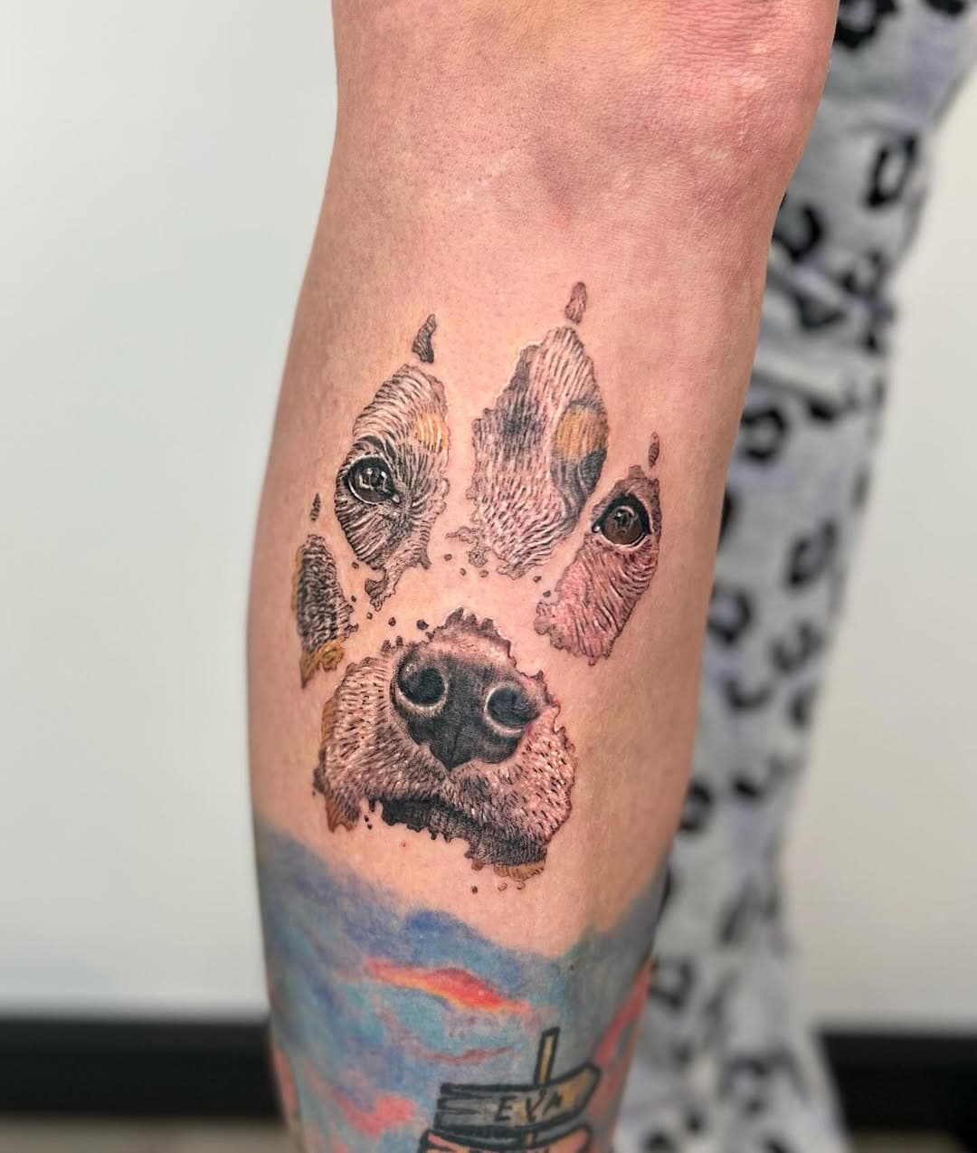 Paw print with her dog’s face inside of it😍🐶🐾 Thanks for the trust Els! I loved working on this project and I’m especially surprised with how much I liked doing a colour tattoo, since I rarely work with colour ink! 
The colour tattoo underneath the paw print is NOT my work tho :)
•
Well if you like this tattoo DM me if you’re interested in getting something like this!
Done at @fempiretattoostudio 
•
•
•
•
#colour #colourtattoo #tattoo #realism #realismtattoo #tattoos #inked #inkedgirls #tatted #tattooart #tattooartist #artist #amsterdam #colortattoo #dog #dogtattoo #legtattoo #tattooed #tattooideas