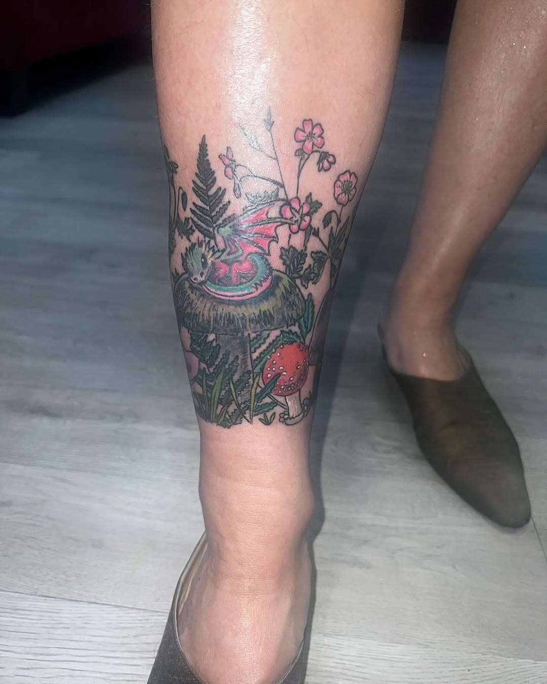 Baby dragon with wildflowers and mushrooms  #scarletmoontattoos #stauntonva #margarethurtme #shenandoahvalley #femaletattooer #femaletattooartist #tattoo #tattoos #allegoryink #solidink #eternalink #ankletattoo #flowerstattoo #dragontattoo