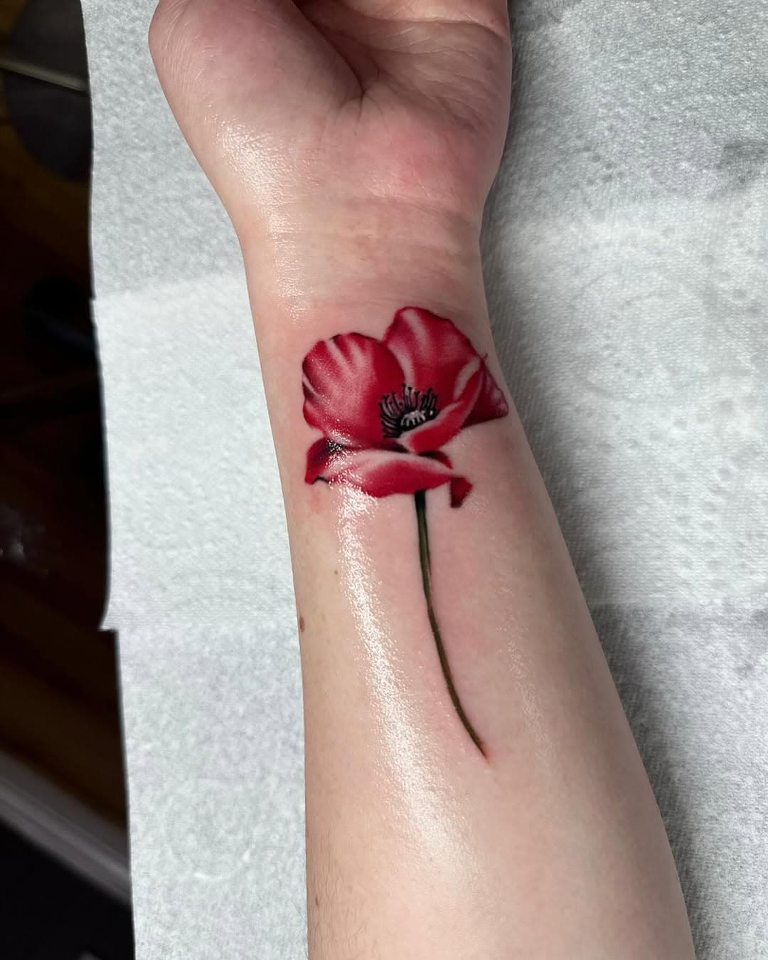 Poppy flower done today by @annaelizabethtattoos