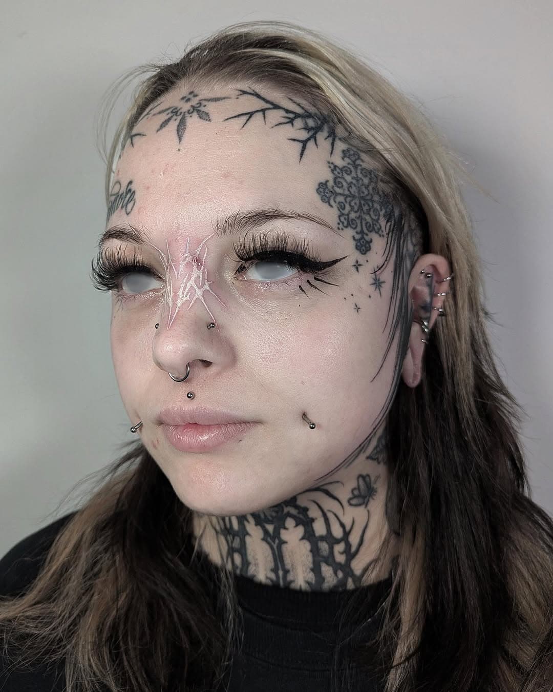 Nose tattoo with white ink this time ✨🤍
(Redness is just their bridge piercing)
.
Also both sides of the face on the same day
.
Sponsored by @kwadron 
.
@swansttattoo 
.
.
#tattoo  #tattooist #artist
#blacktattoo #darkartandcraft #blackwork #blackink #onlythedarkest #onlyblackart #otd #btattooing #darkart #blacktattooart #instagramart #insta_blackwork #occultarcana #artesobscurae #uktta #blackworktattoo #uktattooartist #inkedmag  #bkktattoo #tttism #darklettering666 #kwadroninx #kwadron