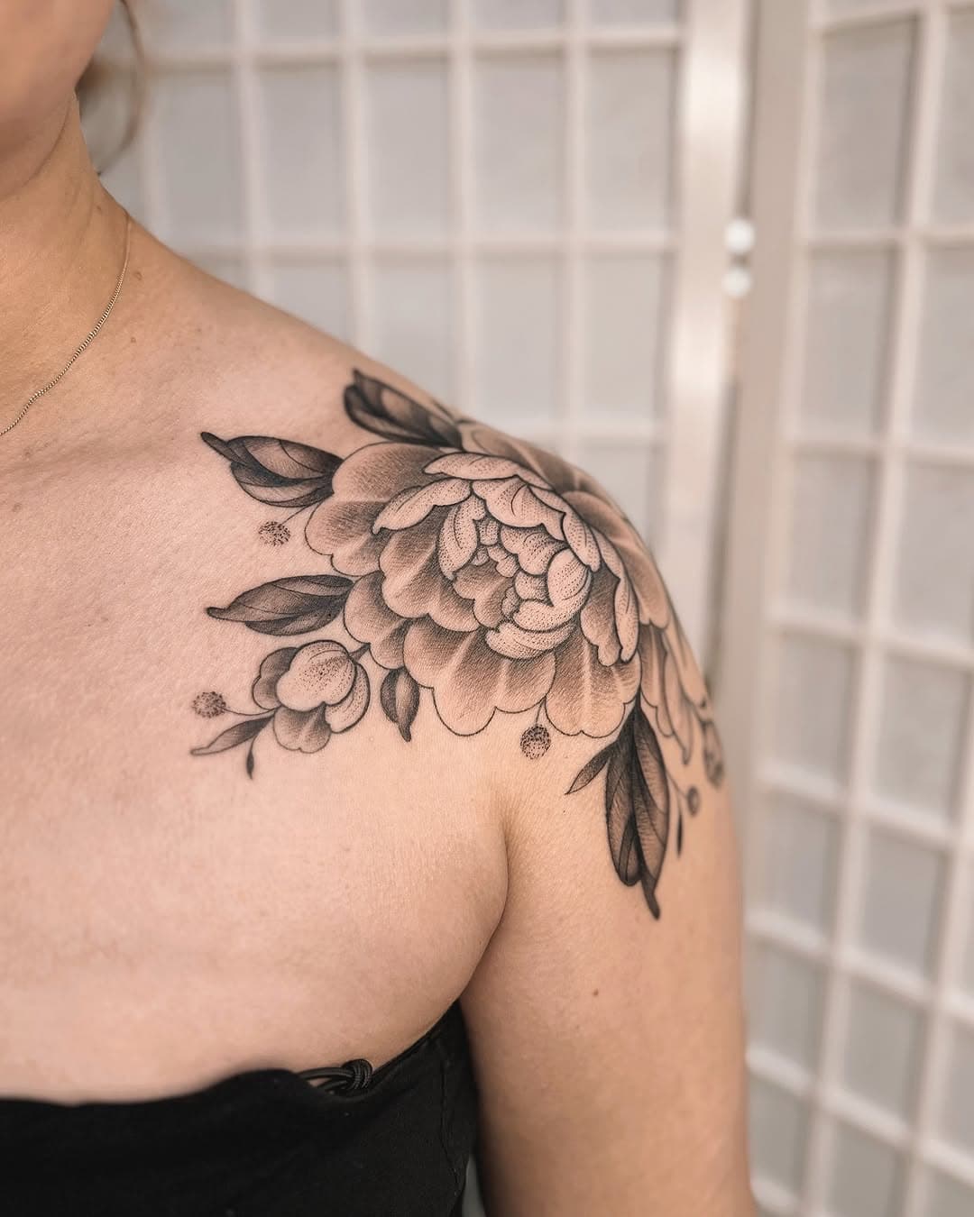 😍😍😍 everyone please give me your shoulders so I can tattoo pretty symmetrical flowers on them I beg!! 🌸 
I am utterly obsessed with how these beauties came out for Abi. We lined them on the first session, and then shaded both yesterday so the lines are healed. The grey shading on the inner petals will heal to a lovely light soft grey wash & the rest was black ink to get that luvvvvly contrast 🙌🏽 Will share a healed pic when Abi is next in!! ✨
•
Made at: @ablastudios 🤎
Sponsored by: @mothtattoosupplies, @butterluxe_uk, @wbjtattoo & @getink.app 
•
•
•
•
•
•
🏷️ 
#armtattoo#botanicaltattoo#shouldertattoo#prettytattoo#tattooideas#tattoos#tattooinspo#tattooart#tattooartist#femaletattooartist#ladiesoftattooingworldwide#uktta#uktattooart#uktattooartist#blackworktattoo#dotworktattoo#peonytattoo#tattoolife#essextattoo#rayleightattoo#peony#peonytattoos#japanesetattoo#peonies#floraltattoos