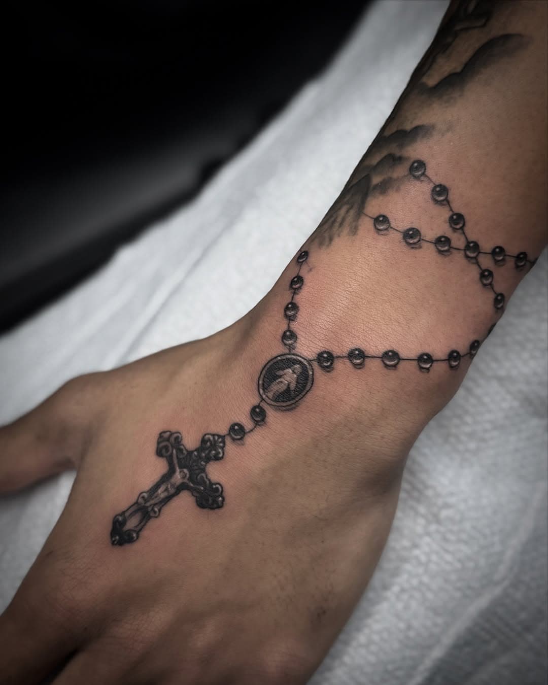 Rosary 📿 in smooth black and grey 
Done by our resident artist @tattoosbytessa_ 
•
For booking contact her directly or send us a DM 
•
•
•
#tattoosbytessa #goldmindstattoo #goldmindstattoogallery #rosary #blackandgrey #realism #blessed #florida #inkyourstory #fyp