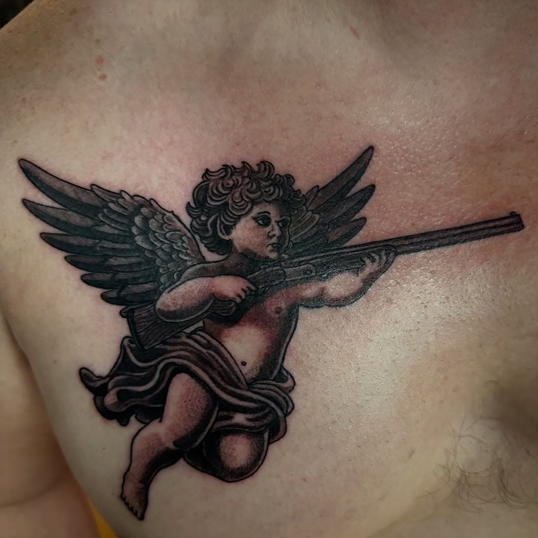 Cherub with a shotgun. Done at @theinkeeperstattooparlor . Stop by for consultation or call for walk in availability. (234) 214-8857.