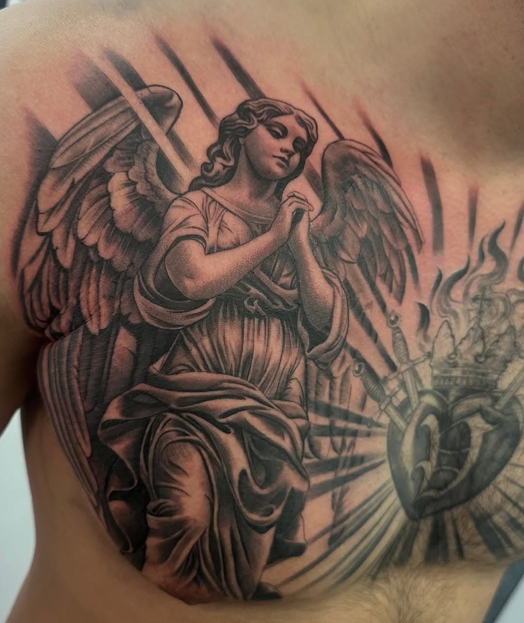 Praying angel in addition to his full chest in progress. SWIPE for video. Will post the whole project healed soon. Thanks for looking! | For bookings DM| @bishoprotary #tattoo #yyz #toronto #blkxgryallday #tattooideas #angel #angeltattoo #chicago #chicagotattooconvention