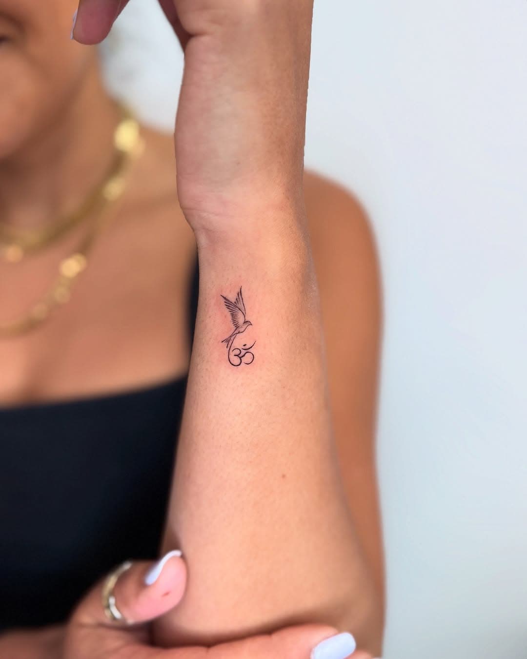 Om and bird for Rhea. It was good to see you again 🙏🏽 I tattooed her mom, sister and her in 2021 🥰 
Now booking for March and April ❤️
.
.
#circatattoo #finelinetattoo #finelines #dainty #instagood  #nyctattoo  #tinytattoo #smalltattoo #littletattoo  #om #wristtattoo