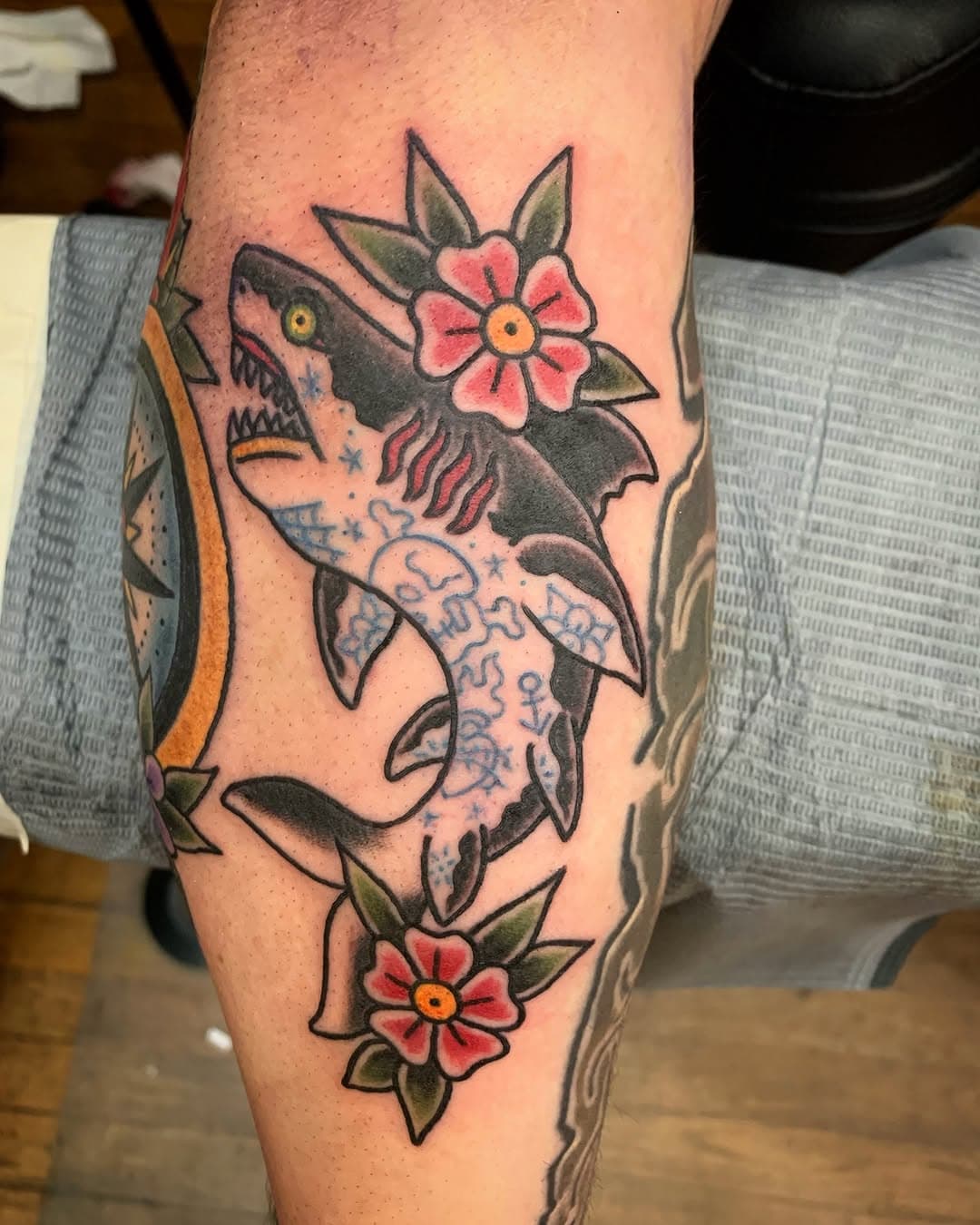 tattooed shark with flowers done at @theinkeeperstattooparlor . Stop by to book you appointment.