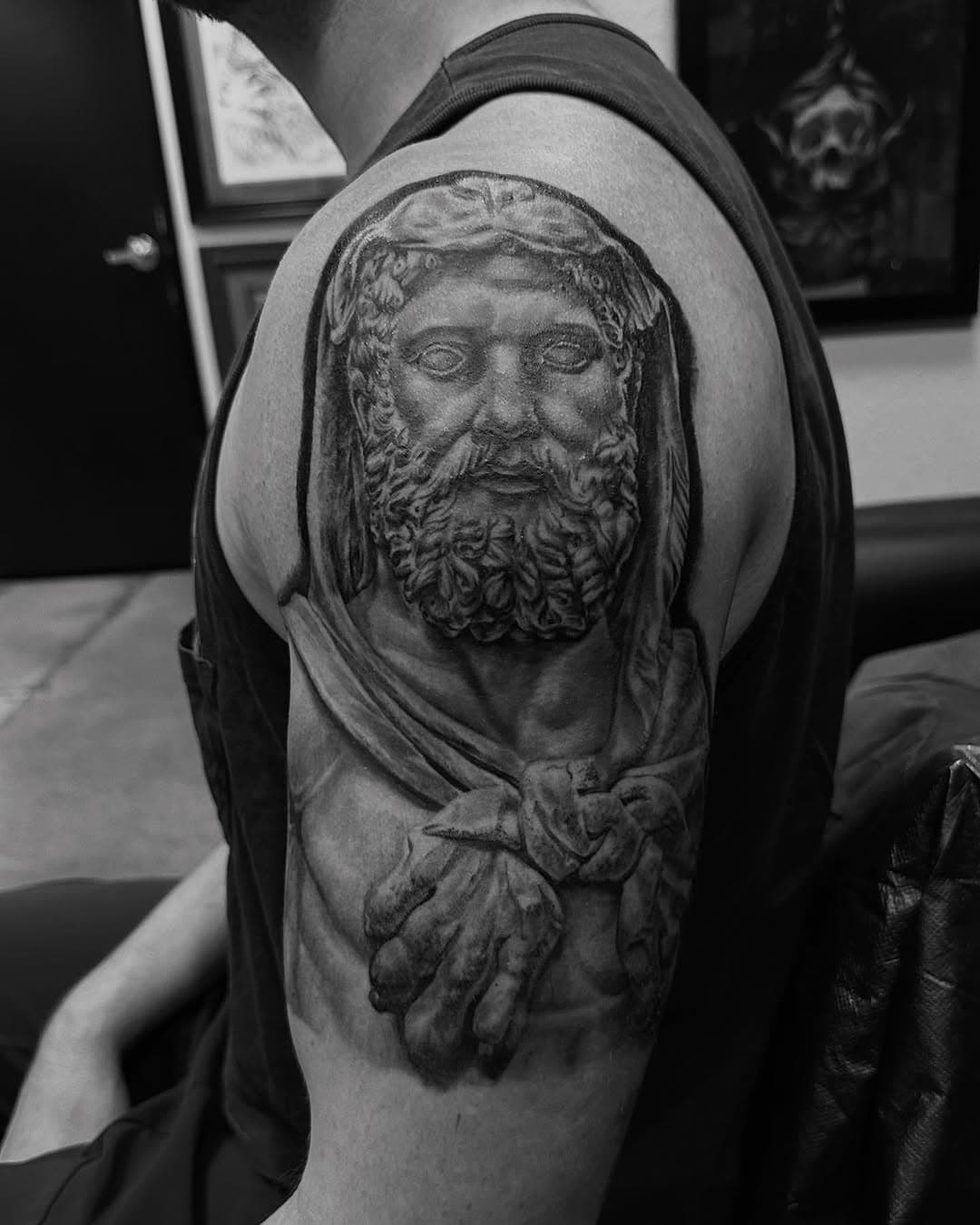 Finished this statue of Zeus For Travis recently. Added a black-and-white to see it uniformly until I can grab a finished photo. Good to have you in the shop bud, and thanks for this enjoyable project. #joelbones #joelbonestattoo #goldrushtattoo #blackandgreytattoo #realistictattoo #details 3dtattoos #topoctattooers #bestocshading #featuredtattoos #superb_tattoos #tattooartmag #bishoprotary