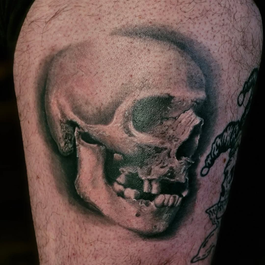 Poured a lot of what I’ve learned during my apprenticeship into this black and grey skull, and I couldn’t be happier with how it turned out! Loved every session on this piece, especially using what was around the studio as reference. It made my first realism piece even more unique.

Definitely keen to do more like this! 

Wanted to show the process from hand stencilling the reference to the complete piece a couple of weeks after the final session.

Would love to do more pieces like this—if you’ve got an idea in mind, get in touch and let's have a cup of tea and chat.