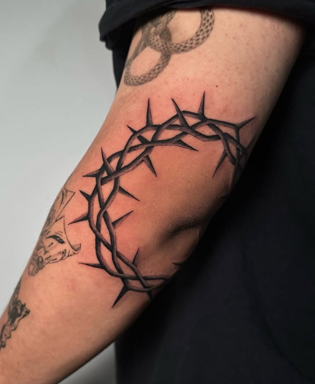 Crown of thorns on elbow by Duda (@o.k.duds) #ochoplacastattoo #blackandgreytattoos #miamitattooartist