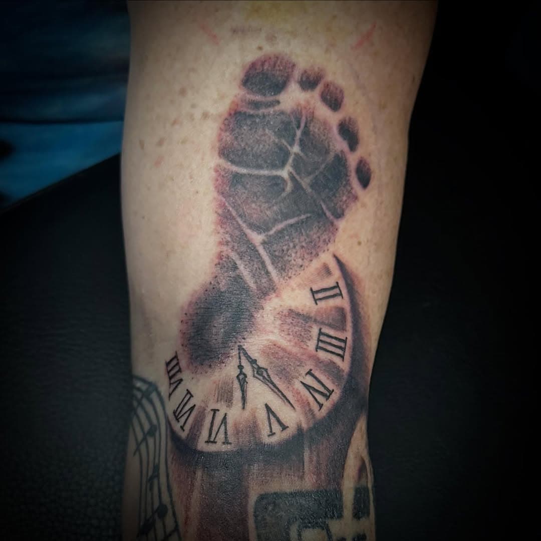 @ksmith48 gets a little foot print for her little foot.  FOR APPOINTMENTS Visit www.garrisontattoo.com  #broketattoos #thegarrisontattoo #stclairshores #michigan #michigantattooer #michigantattooers #michigantattooartist #blackandgreytattoos