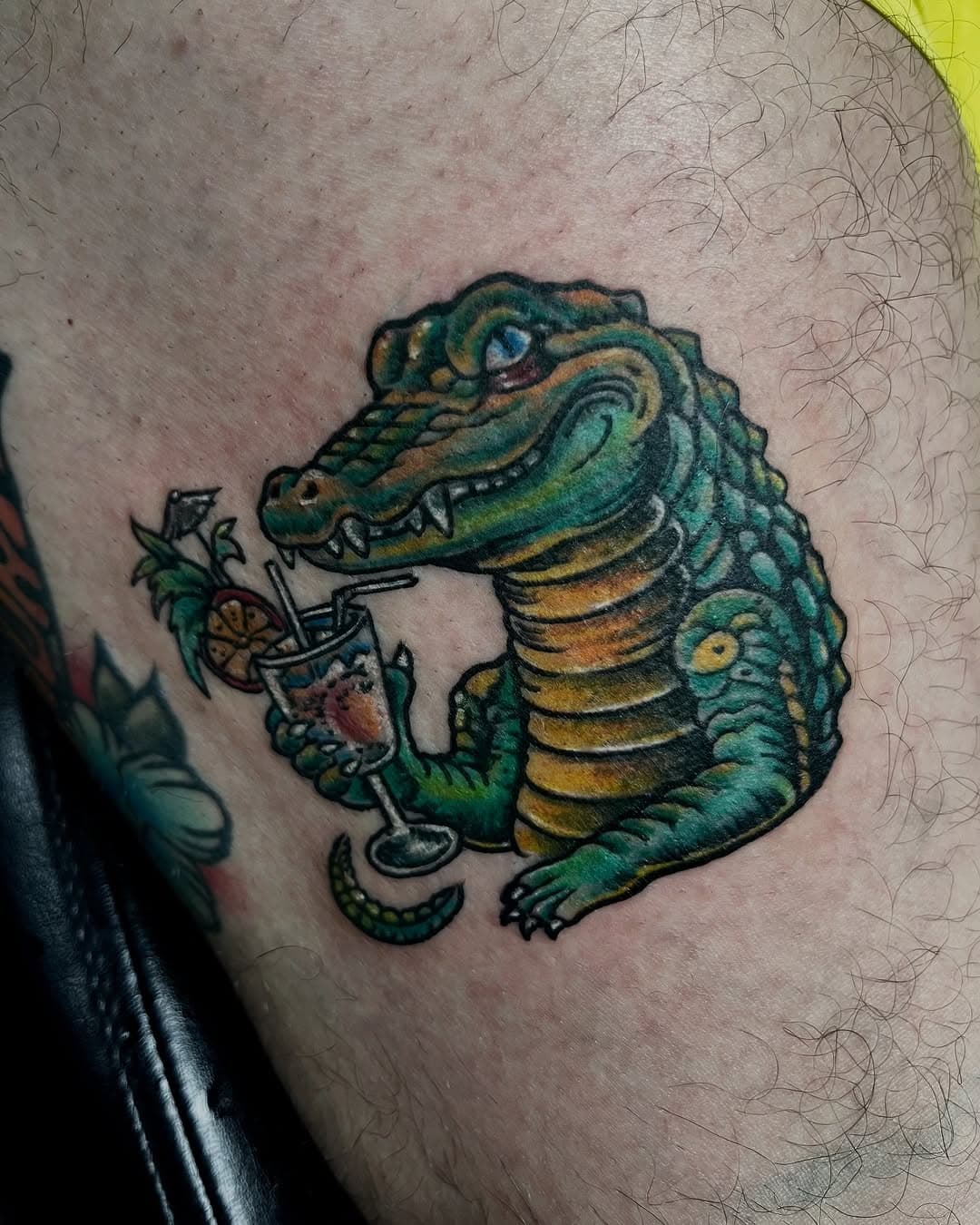 A gator and his cocktail made by @eddieperez.ink @oxygentattoos #gatortattoo #springbreak2025