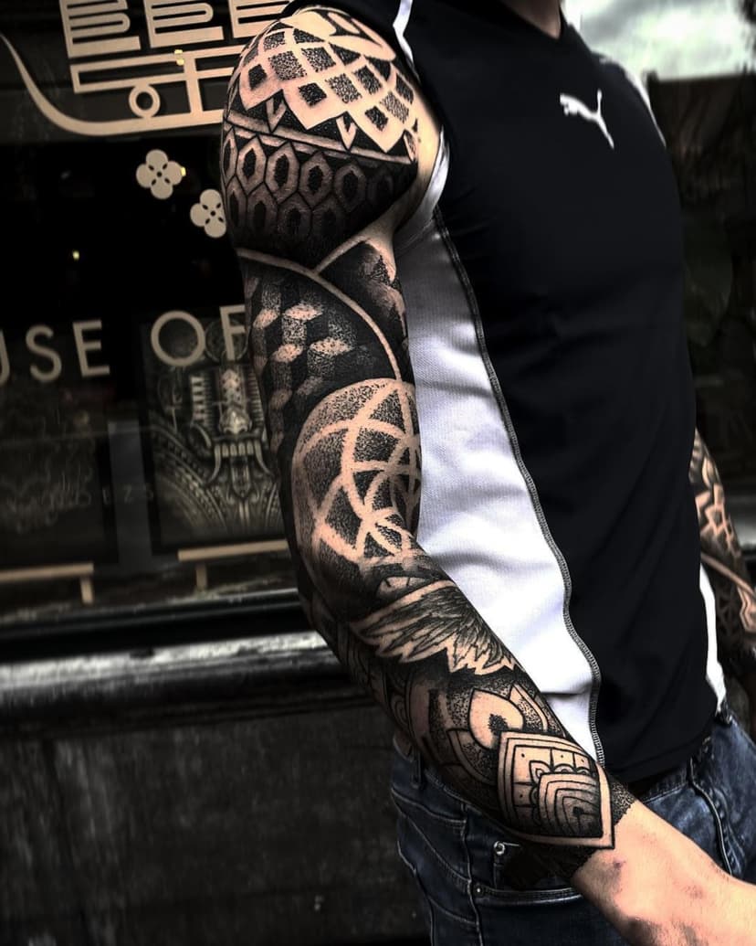 🔥 Precision, contrast & pure dedication! 🔥

This next-level geometric sleeve by @rbsmith is a true masterpiece of patience and skill. The seamless blend of dotwork, linework, and bold black elements creates an intense, structured flow that moves perfectly with the arm’s shape. Every detail is meticulously placed – a symphony of patterns in ink! 🎶🖤

#theinkedarmy #theinkedarmyproteam #tiaproteam #tattoos #tattoosupply #tattoorepost