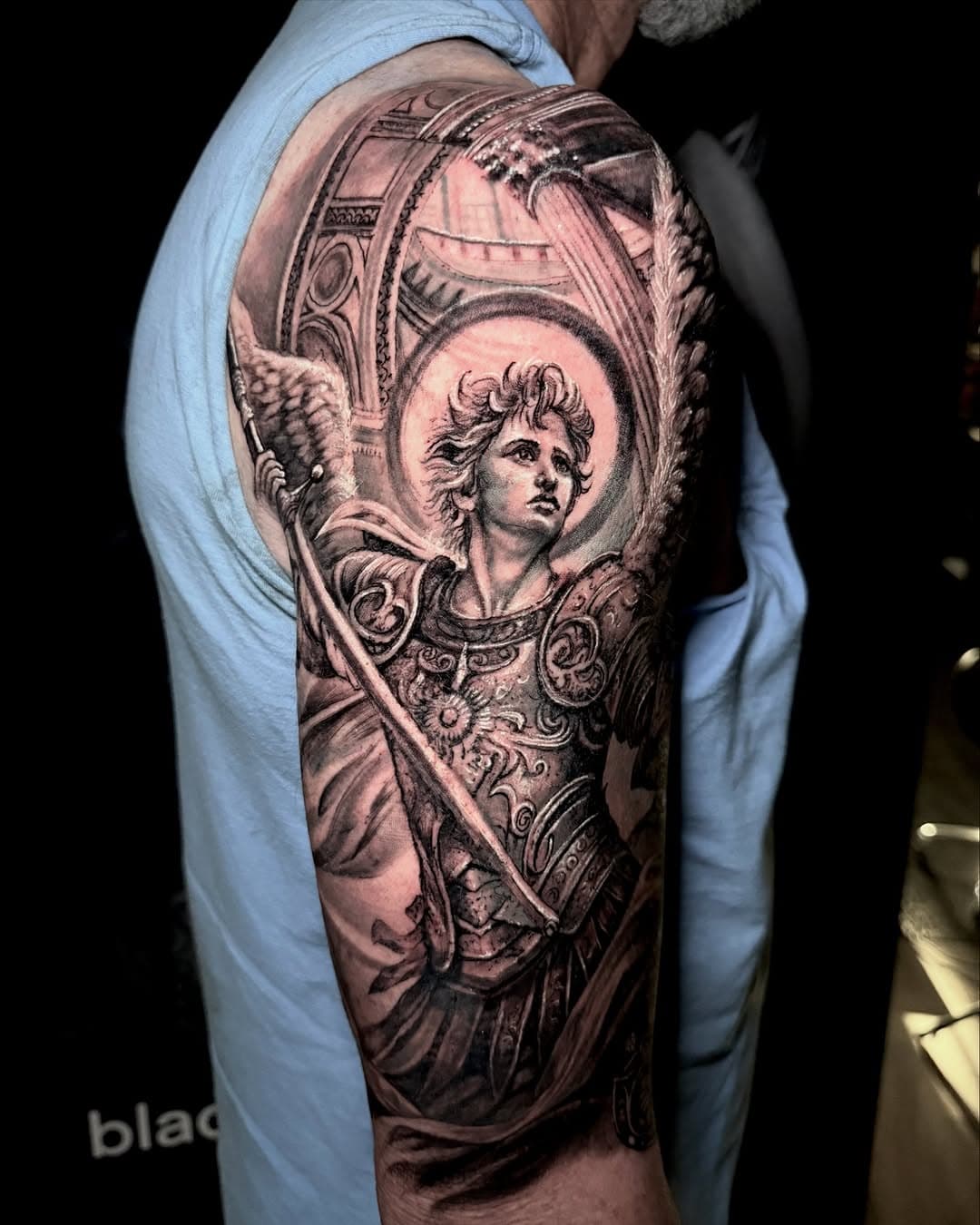 Done @black_forge_tattoo 
Saints Michael is a powerful symbol of spiritual warfare, known for his courage and strength in battling evil forces. 
Defender of God’s People:
He is seen as a protector of God’s people and the Church, often invoked for protection and guidance. 
Leader of Heaven’s Army:
Saint Michael is considered the leader of the heavenly host, leading the angels in their battle against the forces of darkness. 
Patron Saint:
He is the patron saint of various groups, including the military, police officers, and those who work in dangerous conditions. 
Angel of Death:
Saint Michael is regarded as the angel of death, accompanying the souls of departed Christians to heaven 
Weigher of Souls:
St. Michael is often depicted holding balanced scales, symbolizing his role in weighing souls during the Last Judgment